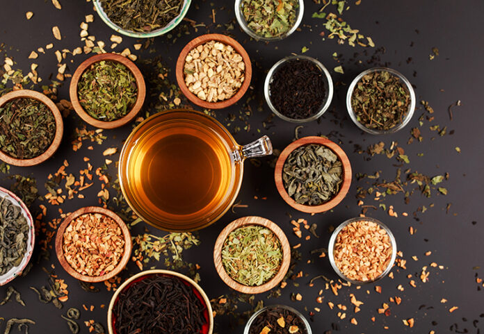 Assortment,Of,Dry,Tea,In,Little,Bowls,,On,Black,Background.